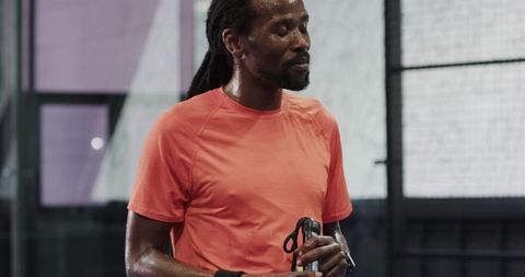 Athletic Male on Padel Court with Racket and Sweaty Towel