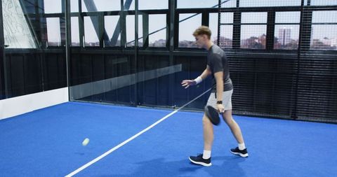 Athletic Male in Blue Padel Court Playing Sport