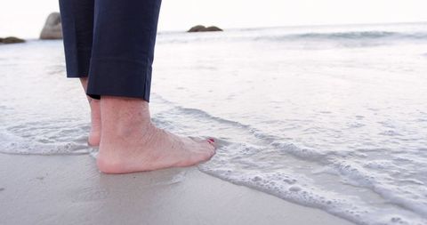Senior Feet on Ocean Shore: Connection to Nature
