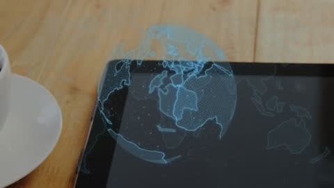 Spinning Digital Globe Hologram Over Tablet in Office Setting