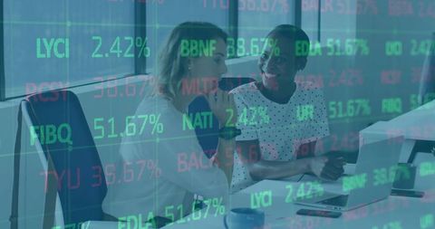 Businesswomen collaborating with market data screen overlay