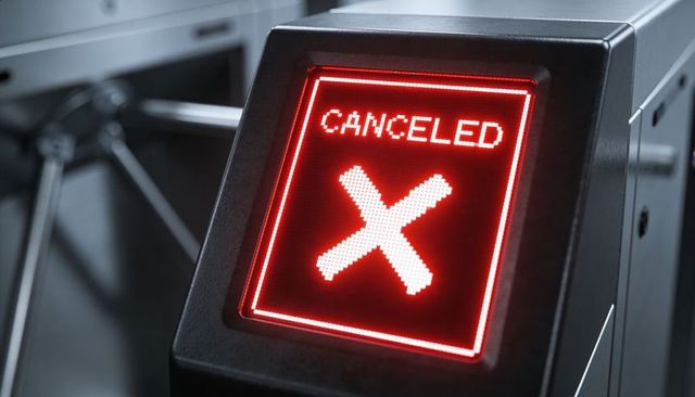 Access turnstile display showing canceled red x on led panel at transit gate entrance