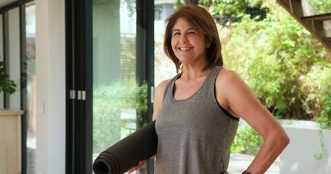 Senior Woman with Yoga Mat Embracing Active Lifestyle at Home