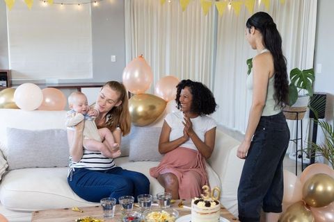 Happy Birthday Gathering with Friends and Baby in Cozy Living Room