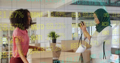 Multiracial coworkers unpacking against stock market display