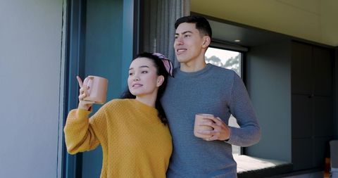 Romantic Couple Relaxing by Window with Morning Coffee