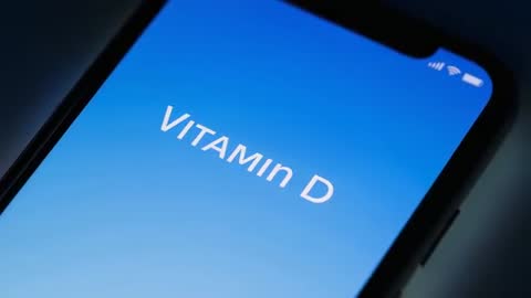 Rotating smartphone screen revealing Vitamin D app interface on blue gradient display