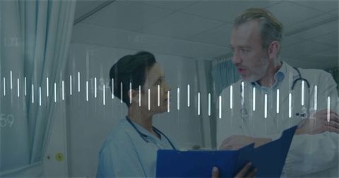 Medical Professionals Discussing Important Reports in Hospital Corridor