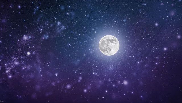 Full moon illuminating starlit purple night with milky way