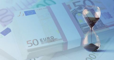 Euro banknotes with hourglass symbolizing time and wealth
