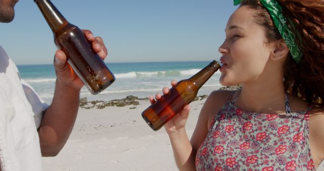 Young Couple Drinking Beer on a Sunny Beach Day - Download Free Stock Images Pikwizard.com