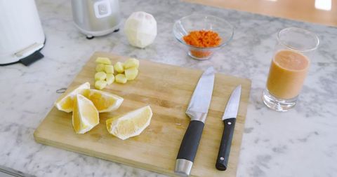 Preparing healthy ginger citrus smoothie in modern kitchen