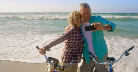 Senior Couple Enjoying Beach Selfie with Bicycles - Download Free Stock Images Pikwizard.com