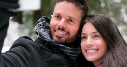 Cheerful Couple Taking Selfie on Snowy Outdoor Adventure