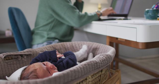 Image of caucasian mother working on laptop from home with newborn baby. motherhood, parental love and taking care of newborn baby concept digitally generated image.