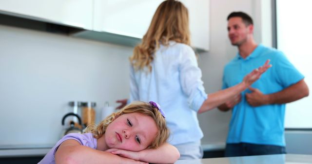 Parents arguing behind their sad daughter at home in the kitchen - Download Free Stock Photos Pikwizard.com