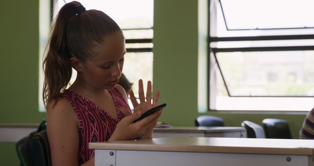 Teen Girl Using Smartphone in Classroom with Green Walls - Download Free Stock Images Pikwizard.com