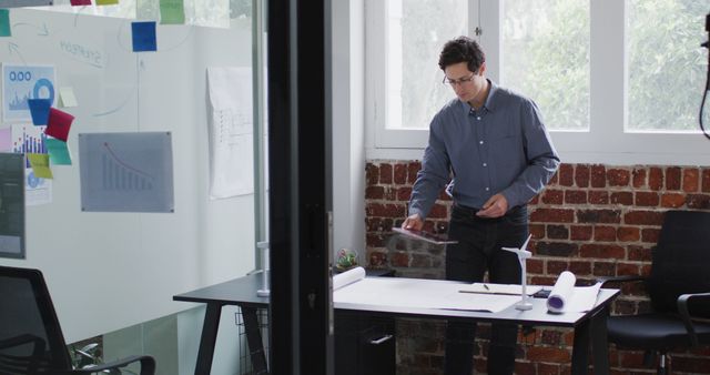 Young Professional Working in Modern Office With Brick Walls and Glass Partition - Download Free Stock Images Pikwizard.com