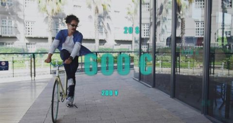 Cyclist riding single-speed bike on urban walkway near palm trees