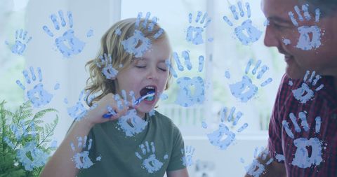 Joyful Boy Brushing Teeth with Visible Blue Handprints Around