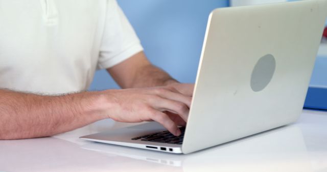 Businessman Typing on Laptop Indoors at Modern Office Desk - Download Free Stock Images Pikwizard.com