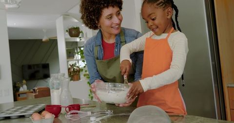 Diverse Mother and Daughter Baking Together in Home Kitchen