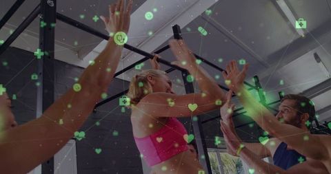 Woman performing pull-up while team gives high-fives with green health tech overlay
