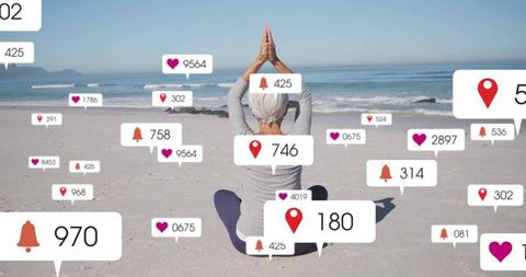 Senior Woman Practicing Yoga on Beach with Social Media Notifications