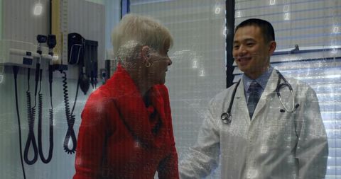Doctor consulting senior patient with digital data overlay