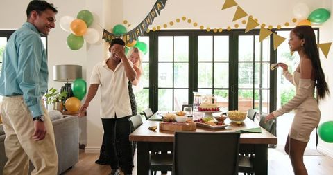 Diverse Group of Friends Celebrating with Enthusiasm at Birthday Celebration