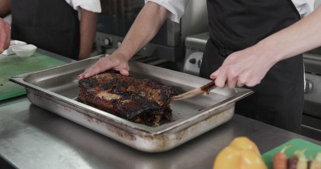 Chef slicing fresh grilled beef brisket in commercial kitchen - Download Free Stock Images Pikwizard.com