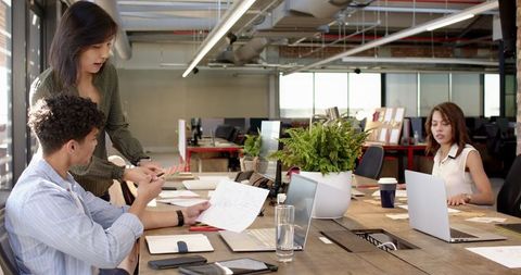 Diverse Team Collaborating in Modern Industrial Office