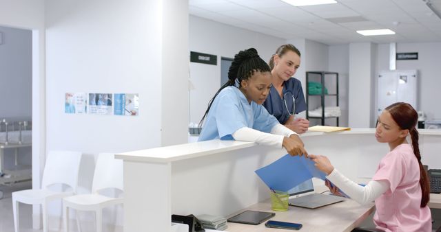 Team of Medical Professionals Collaborating at Hospital Reception Desk - Download Free Stock Images Pikwizard.com