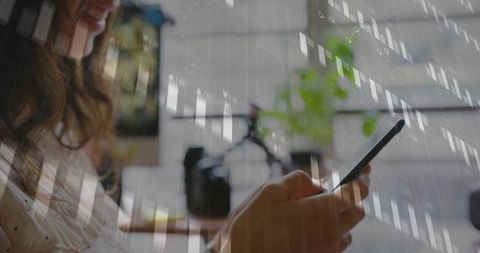 Woman analyzing data on smartphone in modern home office