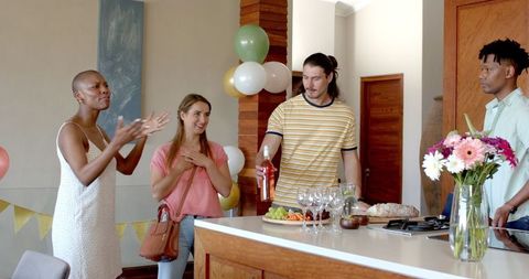 Friends Enjoying Casual Home Celebration with Food and Drinks