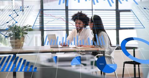 Collaborating colleagues analyzing charts and business analytics on laptop in modern office