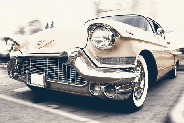 Close-up shot of a 1950s classic car in sepia tone highlighting chrome details and front grille. Excellent for vintage automobile collections, nostalgic themes, automotive history blogs, and old-fashioned marketing materials.