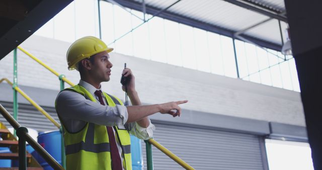 Warehouse Manager Communicating with Walkie Talkie for Logistics Operations - Download Free Stock Images Pikwizard.com