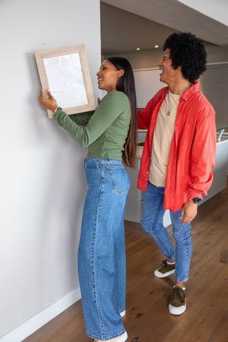 Diverse couple crafting modern home decor together