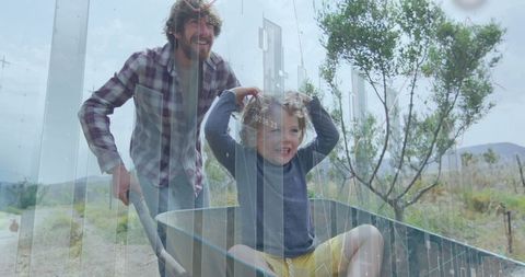 Father Pushing Wheelbarrow with Son Amidst Nature and Data Graphics
