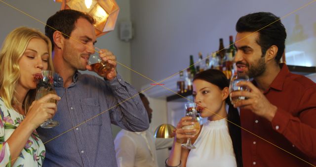 Group of friends enjoying drinks at a stylish bar, perfect backdrop for themes parks such as social gatherings, nightlife promotions, beverage advertisements, or casual social interactions.