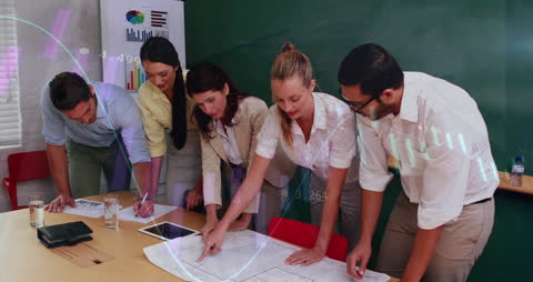 Diverse Team Analyzing Statistics and Financial Data In Office