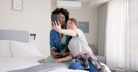 Joyful Couple Taking Selfie in Cozy Bedroom Environment