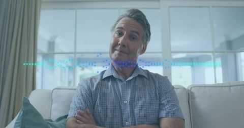 Senior Man Relaxing on Sofa with Digital Overlay in Modern Living Room