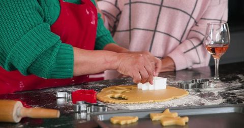 Mother and Daughter Baking Together Cutting Festive Cookies at Home