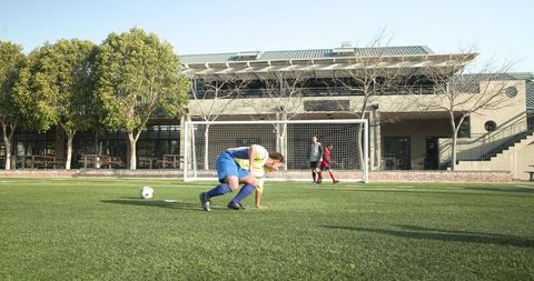 Youth soccer player in action mid-game near goal