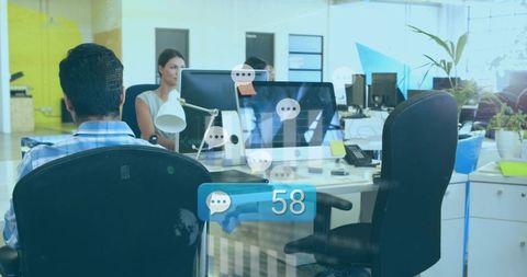 Open-Plan Team Working at Desks Showing Chat Notifications and 58 Message Alert
