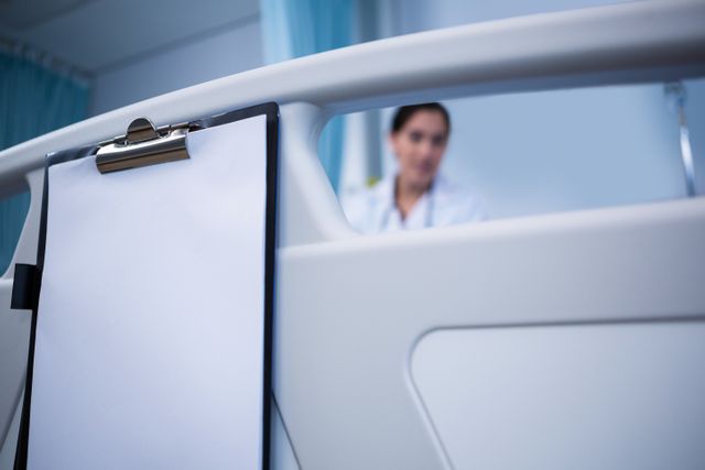 Close-up of clipboard hanging on bed in hospital