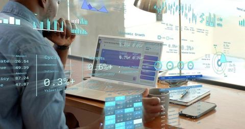 Remote analyst studying financial dashboards on home laptop with holographic data overlays