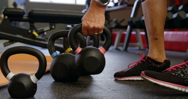 Person Lifting Kettlebell in Gym Environment - Download Free Stock Images Pikwizard.com